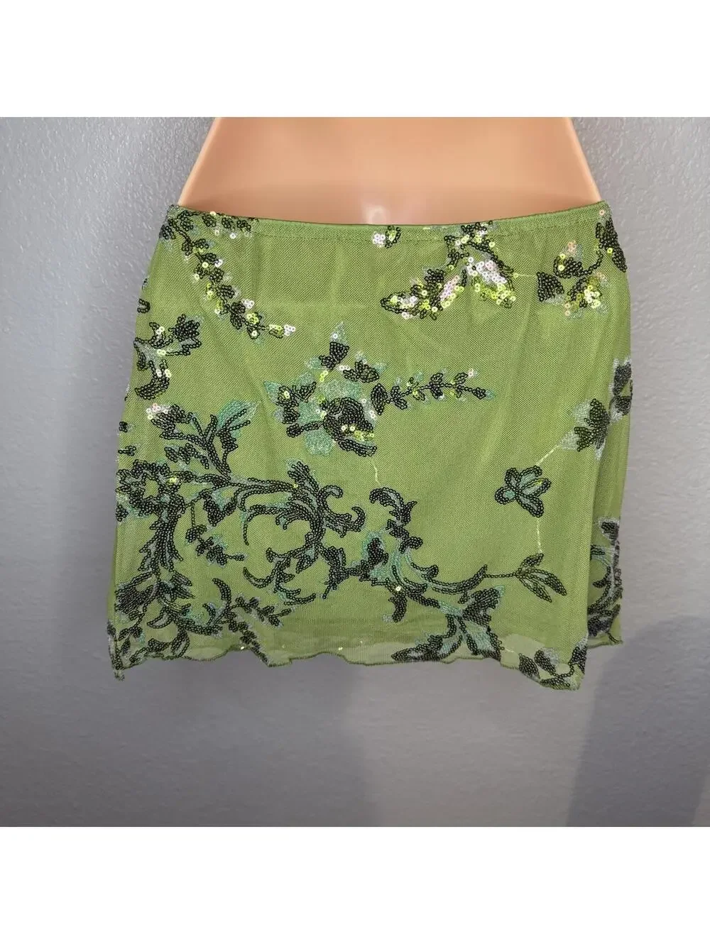 Green beaded mini skirt with black floral embroidery and sequins